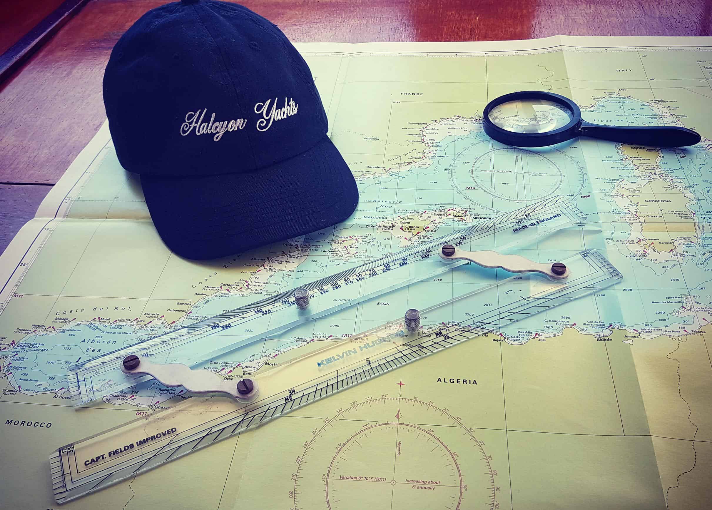 Imray paper charts of the mediterranean with a hat and dividers