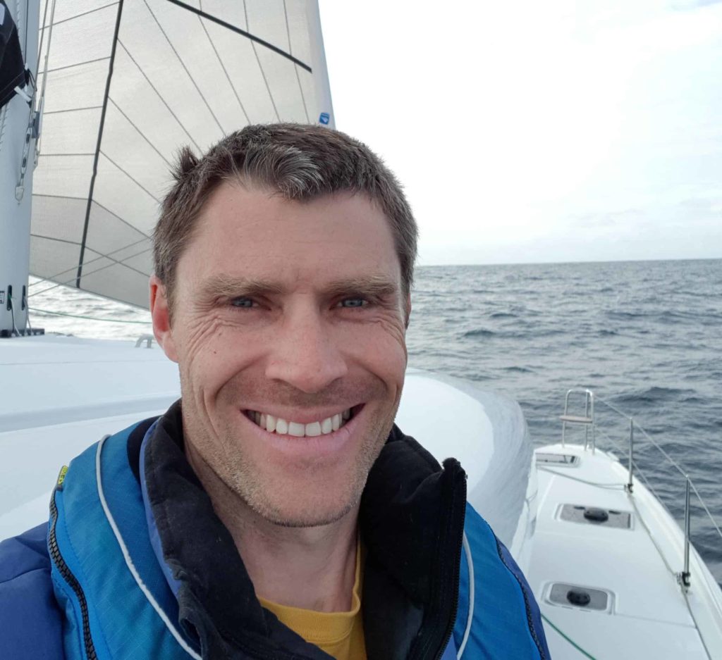 The owner of a Lagoon 42 smiling as he sails to Portugal