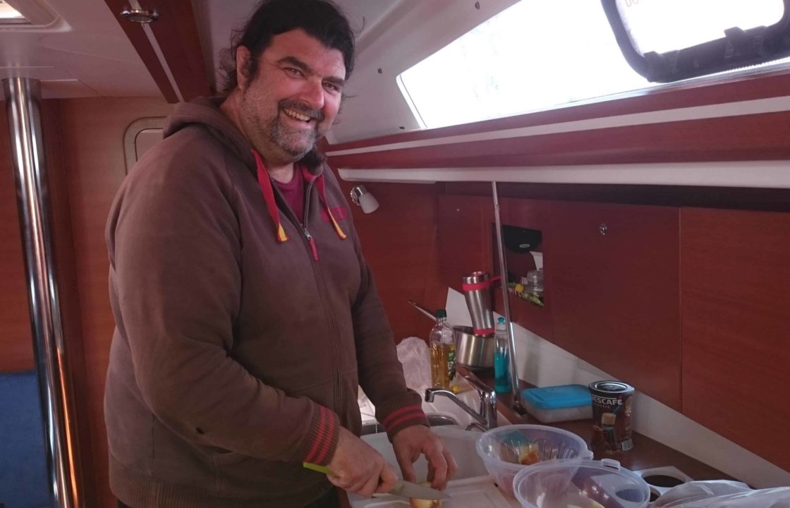 Professional yacht delivery skipper in the galley preparing lunch for the crew