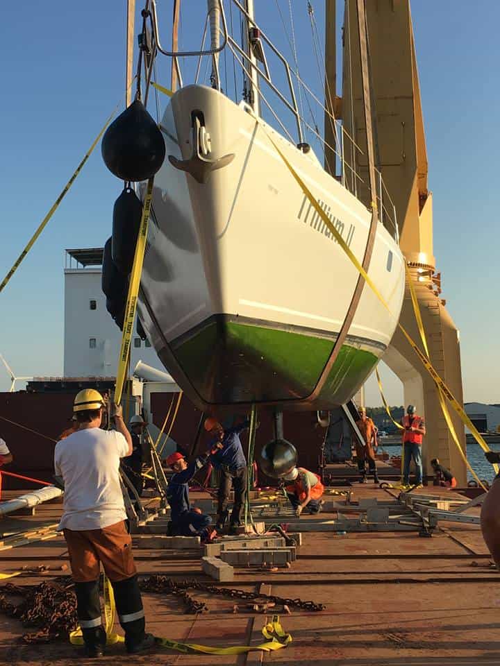 A yacht being loaded by crane onto a shit