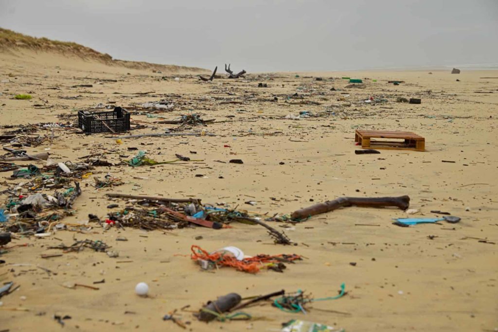 a beach covered in plastic rubbish