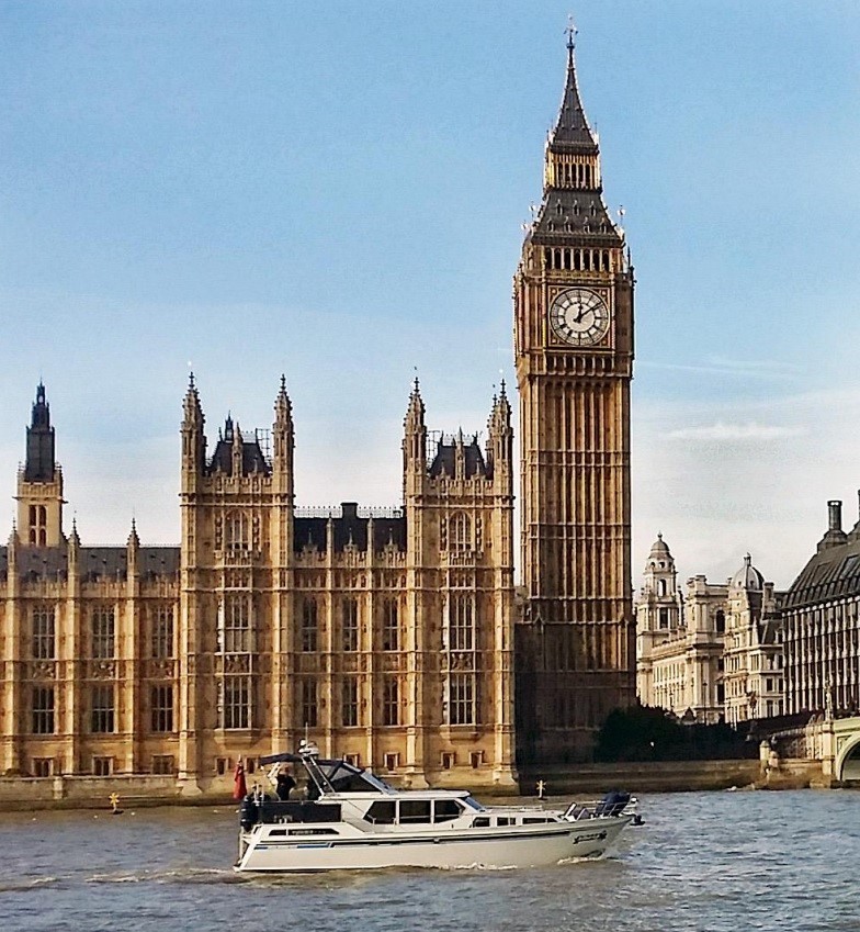 Polaris 1300 GL powerboat cruising down the Thames in from of Big Ben.
