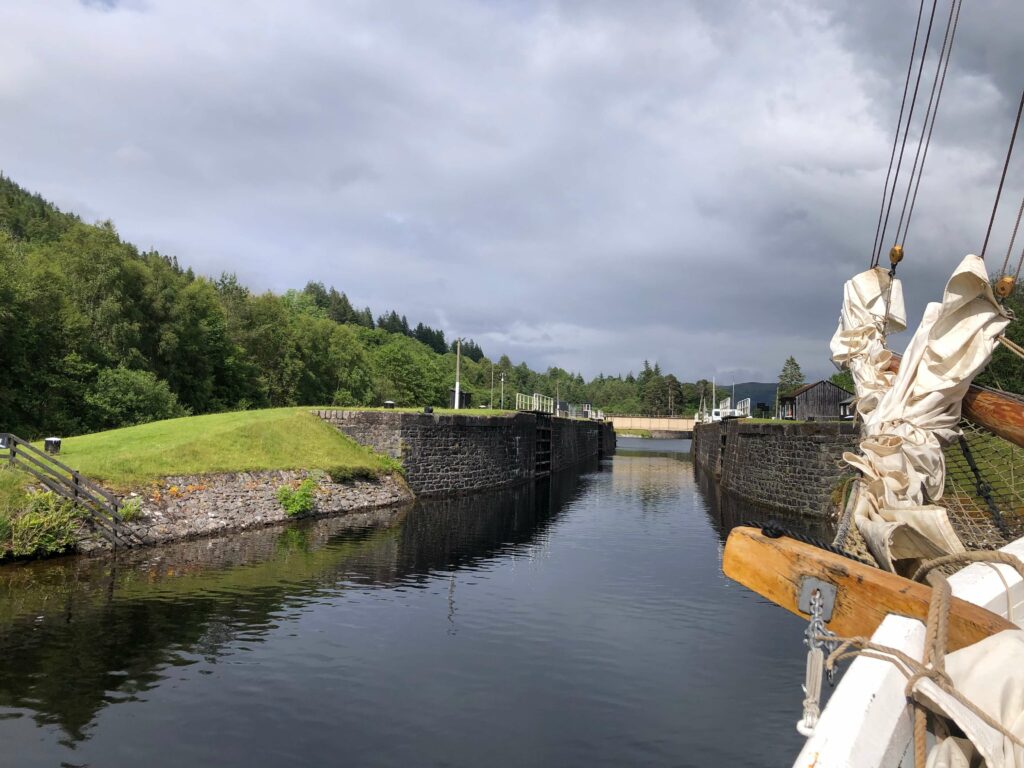 View of classic yachts bow sprit and Gairlochy Locks on the Caledonian Canal