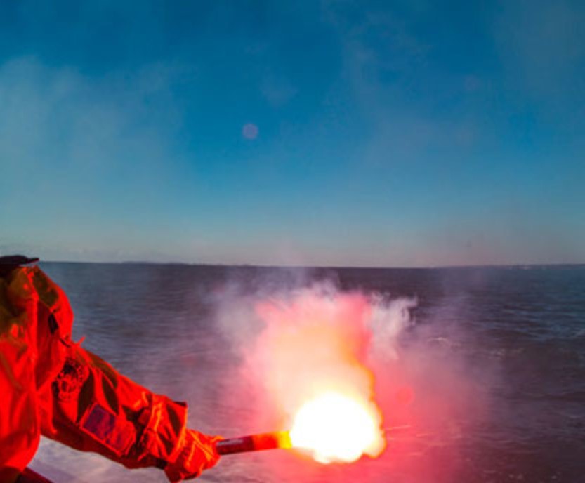 Flares: A Pyrotechnic flare burning orange over the sea