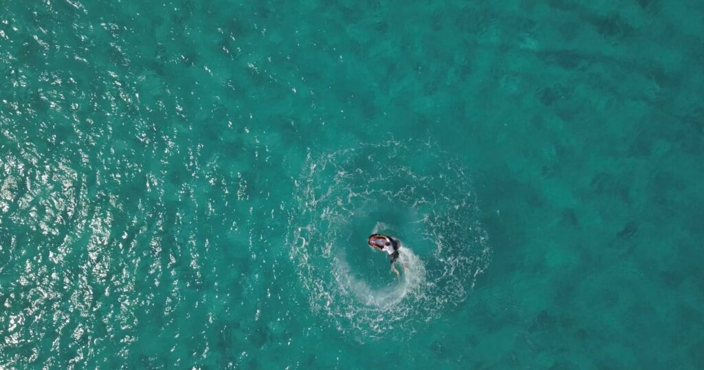ASAP Wavejam board viewed from above doing a circle in turquoise water