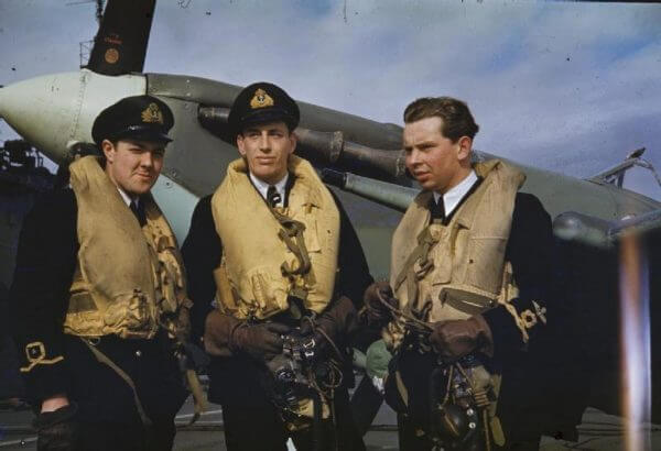 3 World War 2 pilots wearing lifejackets over their uniform.